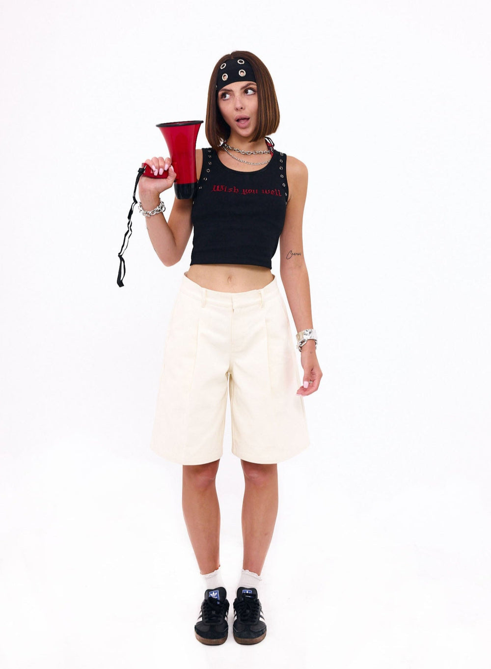 Person holding a red megaphone with a white background