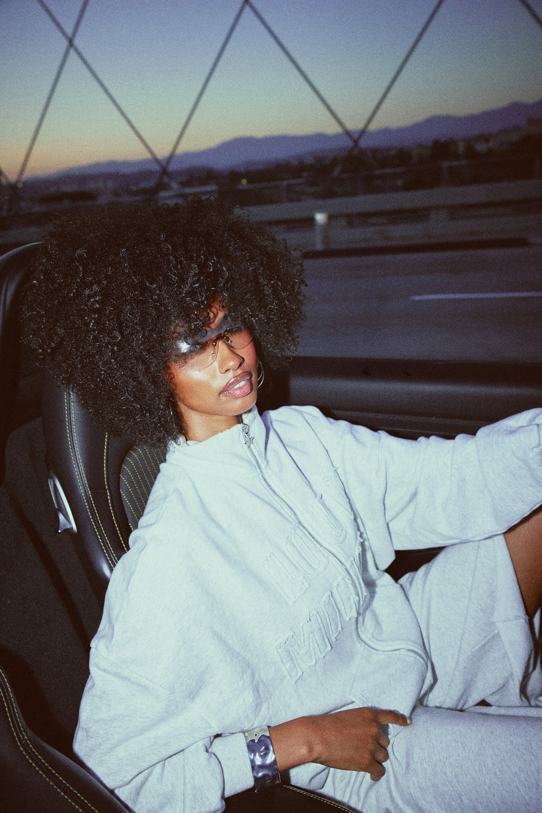 Person sitting inside a car with a scenic background