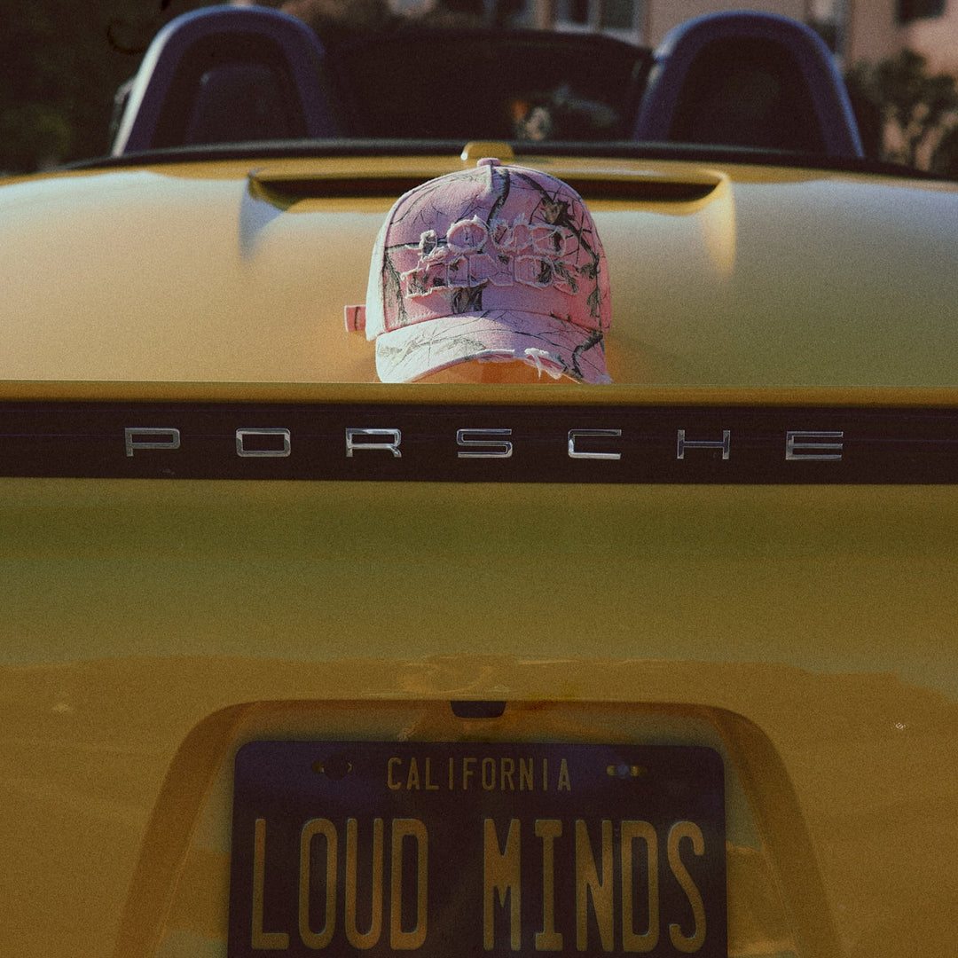 Yellow Porsche car with a cap on the trunk and &