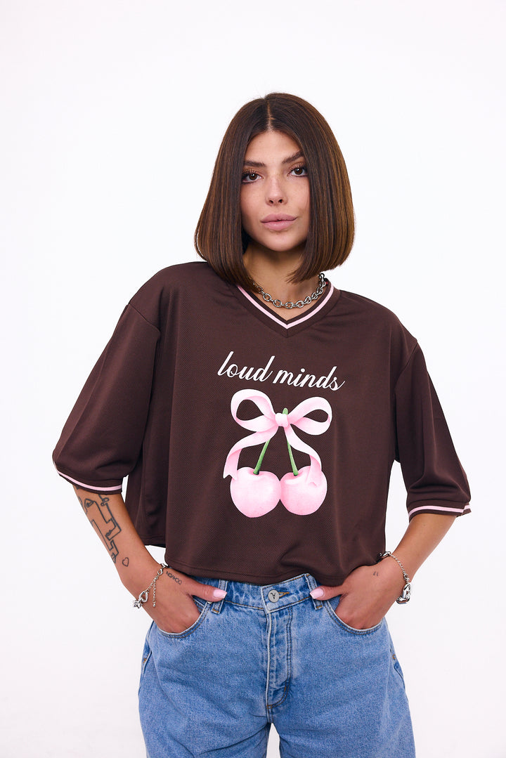 Loud Minds The Juicy Jersey in cropped brown sports mesh with cherry and bow graphic, front view