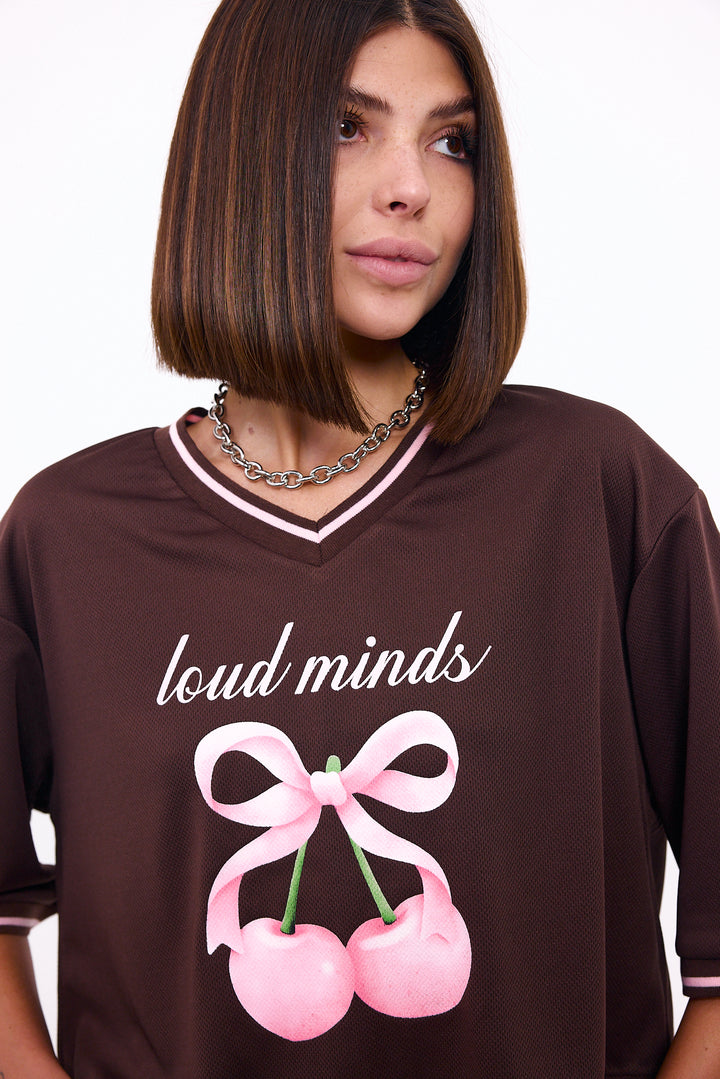 Loud Minds The Juicy Jersey in cropped brown sports mesh with cherry and bow graphic, side view