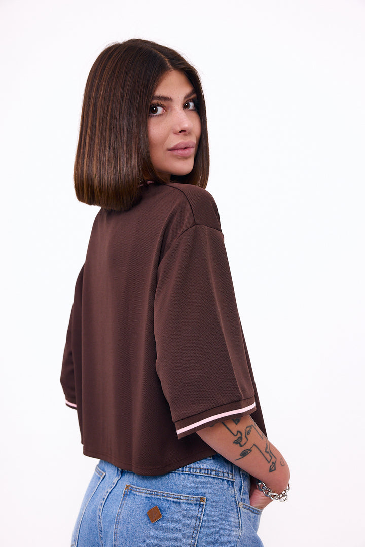Loud Minds The Juicy Jersey in cropped brown sports mesh with cherry and bow graphic, styled on model